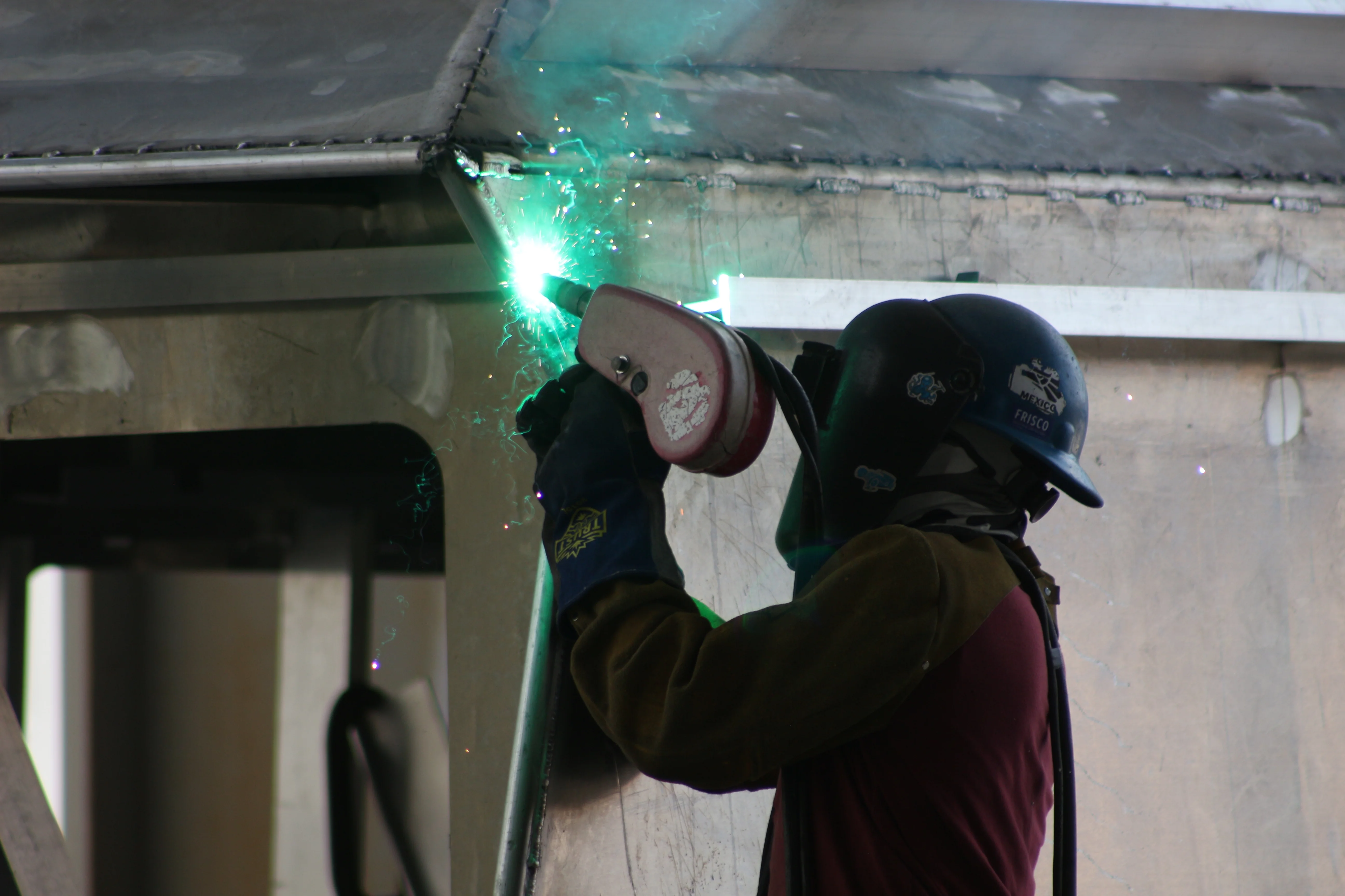 Welder at work on an aluminum vessel hull at the Breaux's Bay Craft shipyard